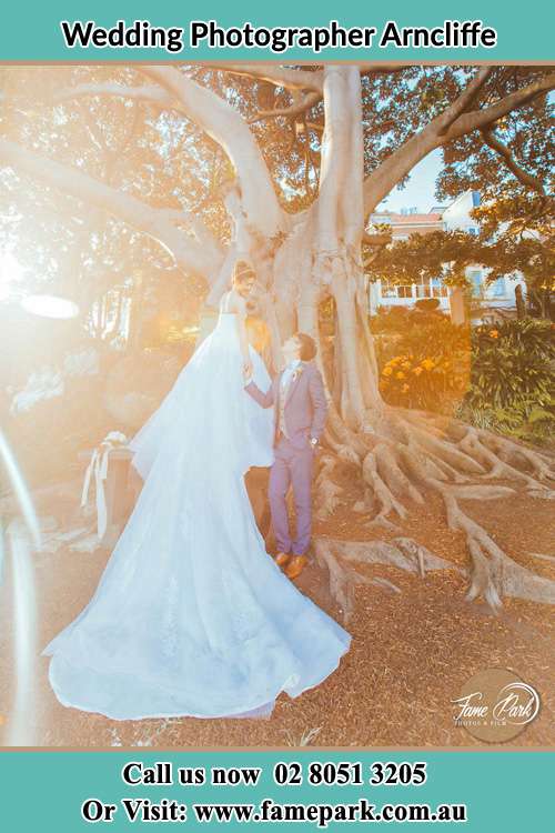 Photo of the Bride and the Groom looking each other beside the tree Arncliffe NSW 2205