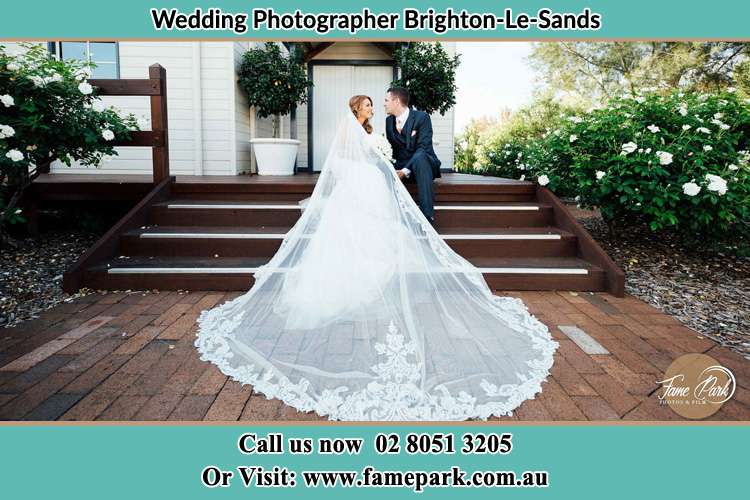 Photo of the Bride and the Groom looking each other while sitting on the staircase Brighton-Le-Sands NSW 2216