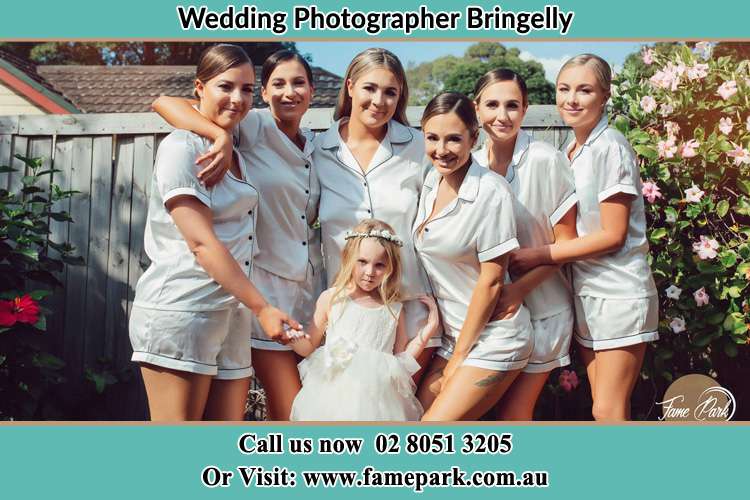 The Bride and the bridesmaids with the flower girl sticking a pose on camera Bringelly NSW 2556